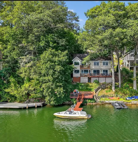 a view of a house with a yard and sitting area