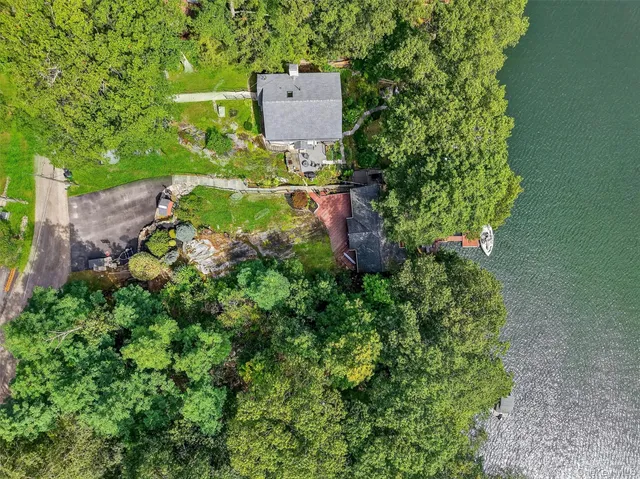 an aerial view of a house with a yard and garden