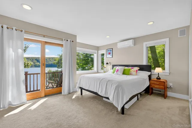a bed sitting in a spacious bedroom next to a window