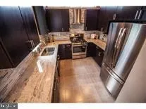 a kitchen with stainless steel appliances a refrigerator sink and stove