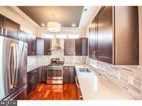 a kitchen with stainless steel appliances granite countertop a stove and a refrigerator
