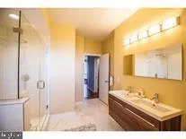 a bathroom with a tub sink and mirror