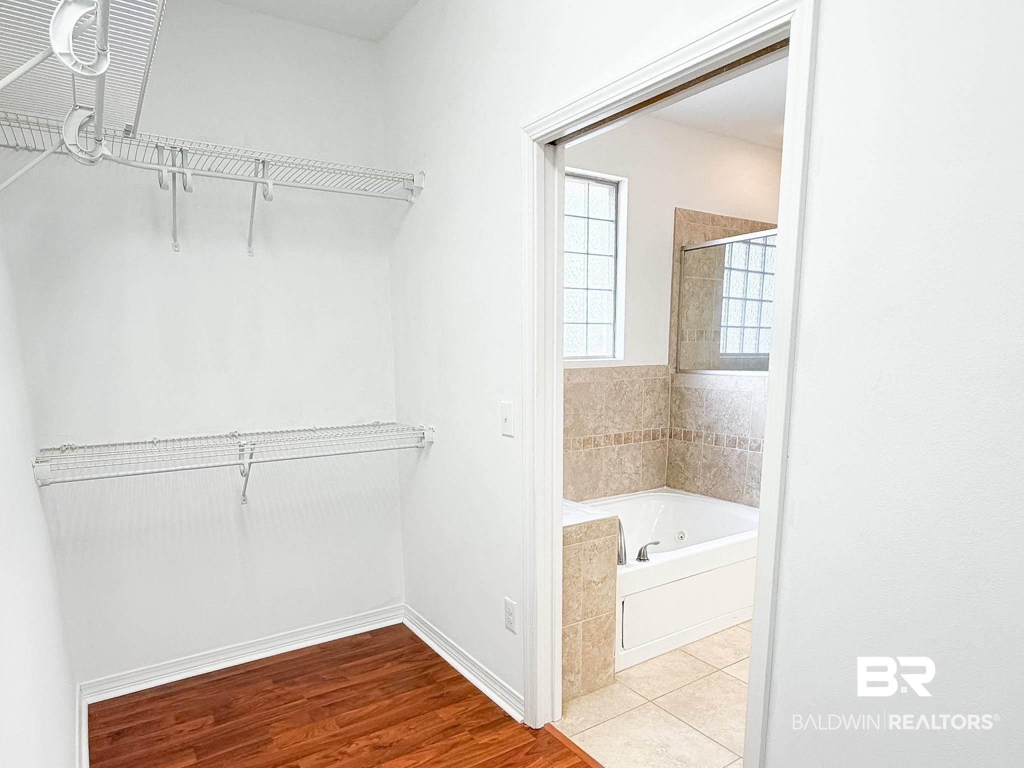 7332 Raintree Lane Gulf Shores, AL 36542 - Photo 14 of 21 Walk in closet featuring wood finished floors