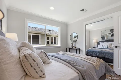 a bedroom with a bed and ceiling fan
