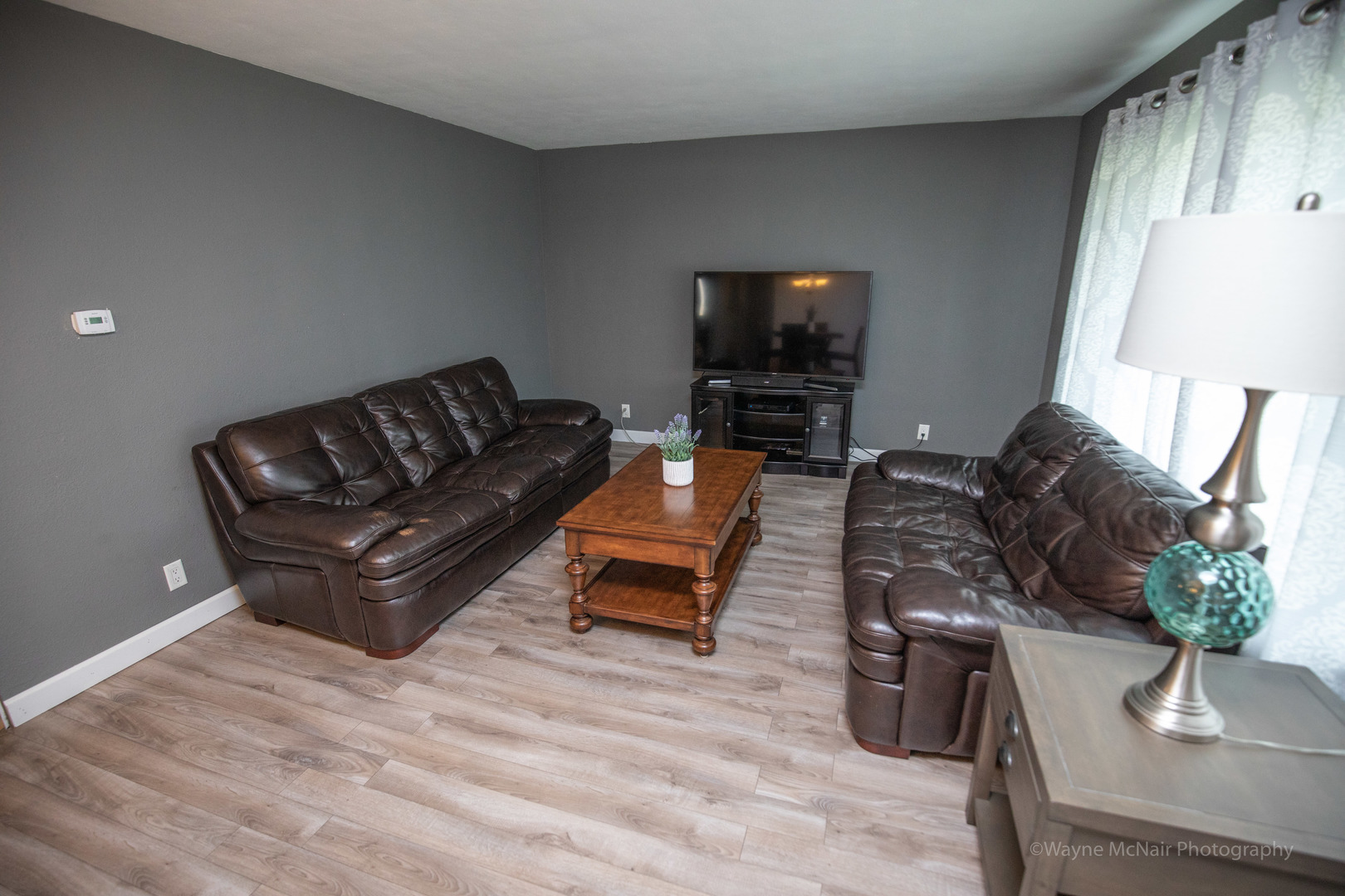 1610 Black Road Joliet, IL 60435 - Photo 4 of 25 a living room with furniture a flat screen tv and a window