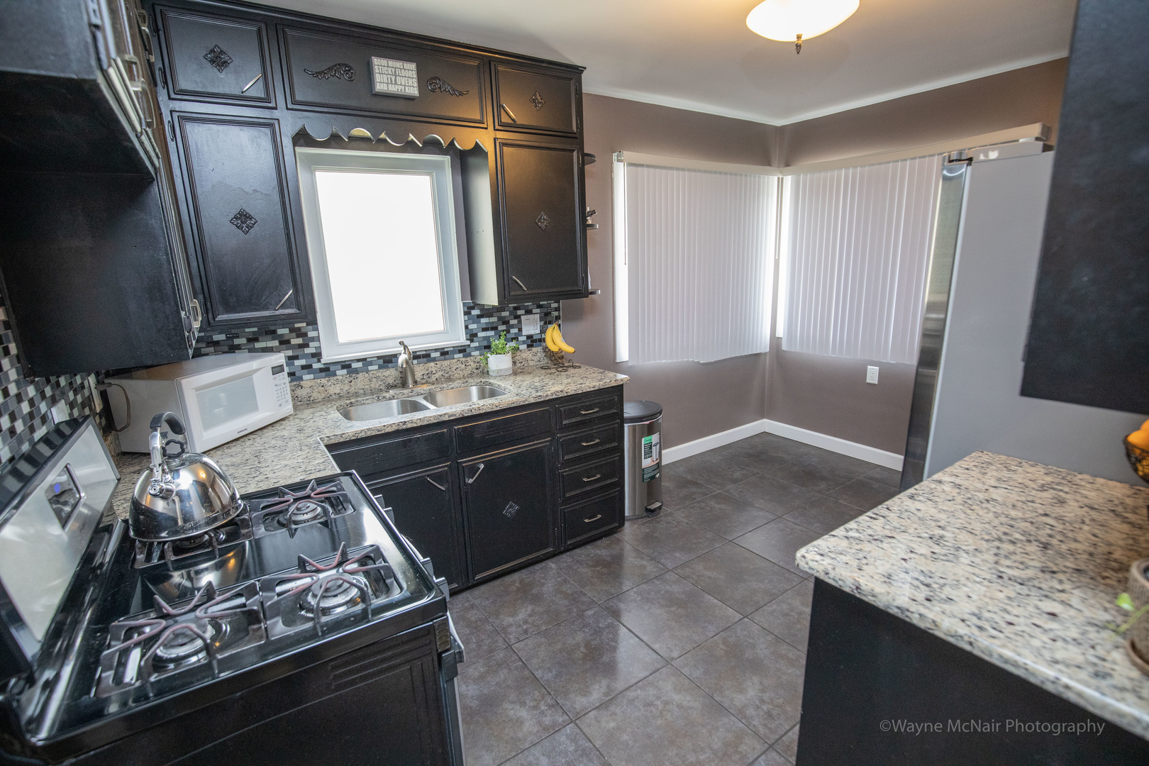 1610 Black Road Joliet, IL 60435 - Photo 7 of 25 a bathroom with a granite countertop sink and a mirror