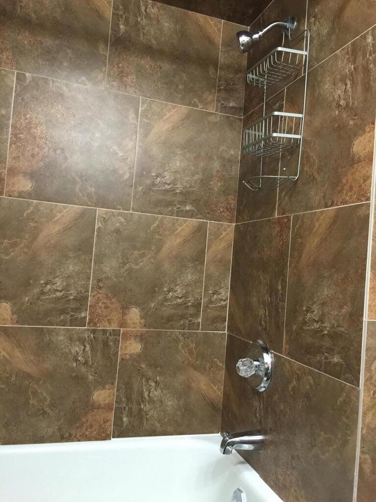 120 Southwest 10th Plainview, TX 79072 - Photo 12 of 27 a bathroom with a shower