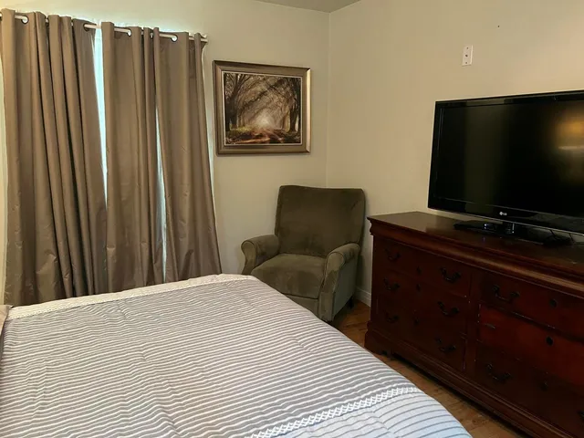 a bedroom with a bed and a lamp