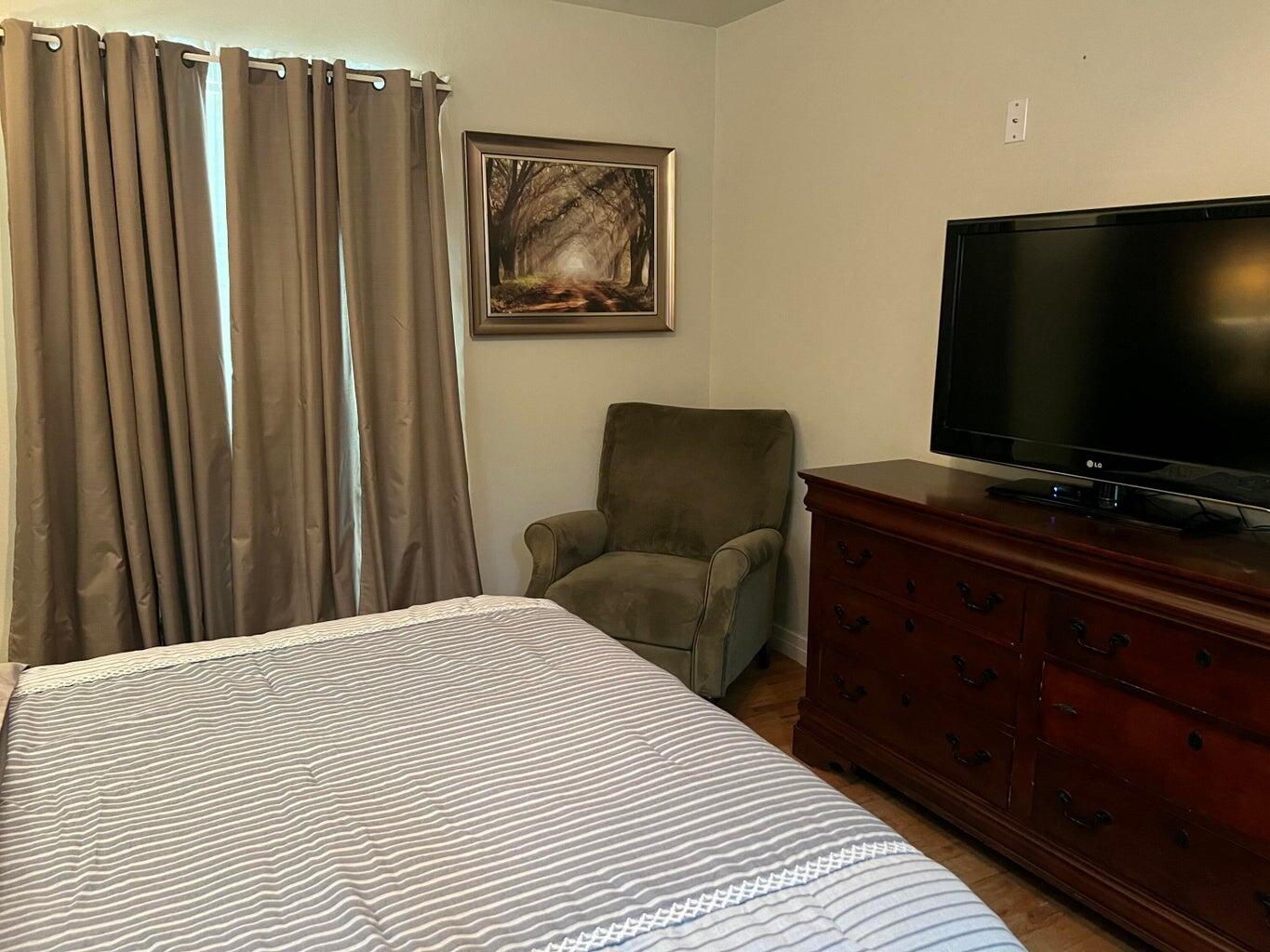 120 Southwest 10th Plainview, TX 79072 - Photo 16 of 27 a bedroom with a bed and a flat screen tv