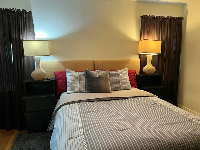 a bedroom with a bed and a window