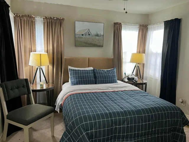 a bedroom with a bed and a table in it