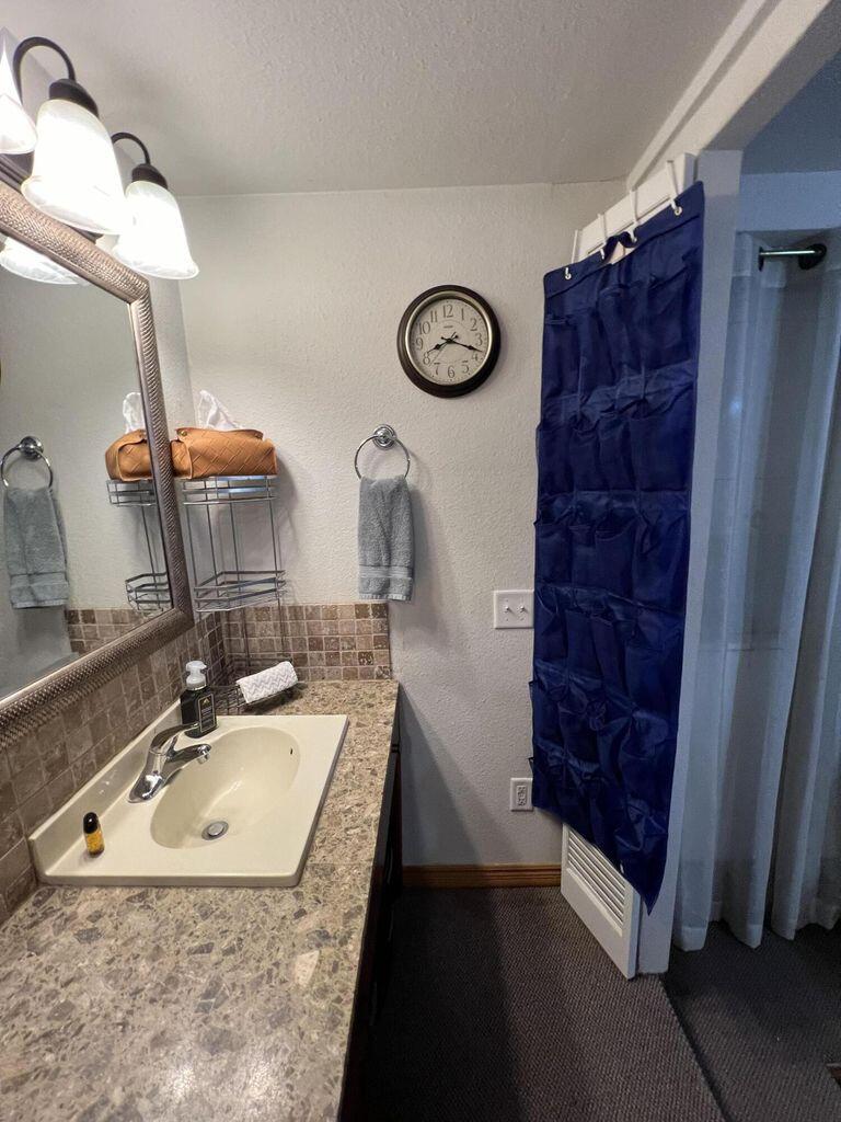 120 Southwest 10th Plainview, TX 79072 - Photo 24 of 27 a bathroom with a sink and a mirror