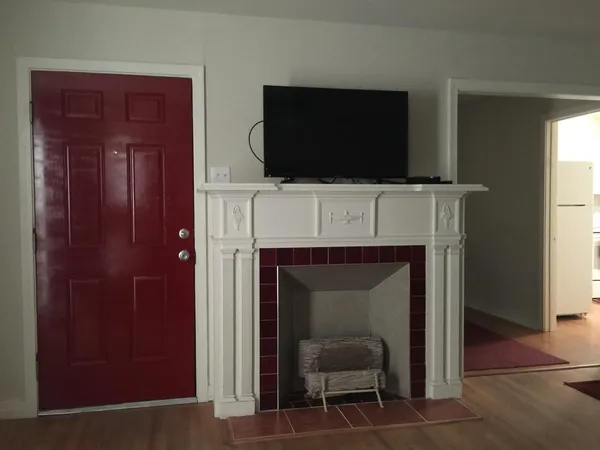a living room with a fireplace and a flat screen tv