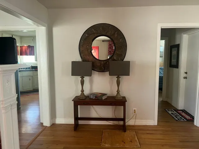 a kitchen with granite countertop a stove a sink and a refrigerator