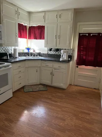 a view of a dining room with furniture and rug