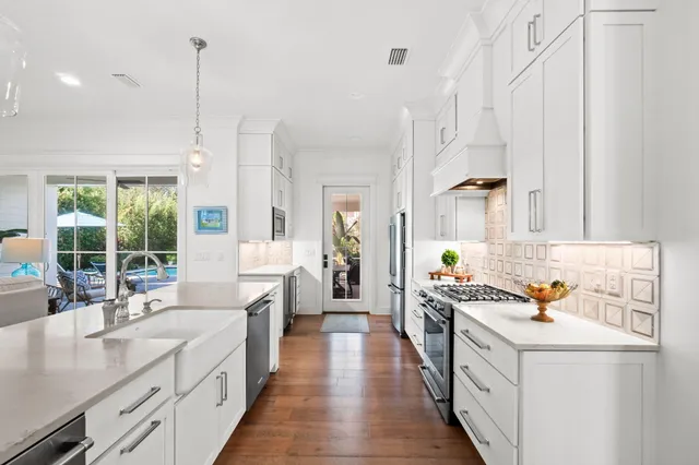 a view of a swimming pool with a table and chairs under an umbrella
