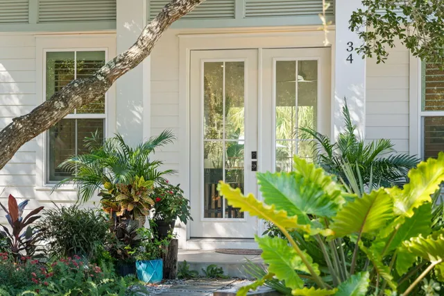 a large kitchen with granite countertop a stove a sink a center island and cabinets