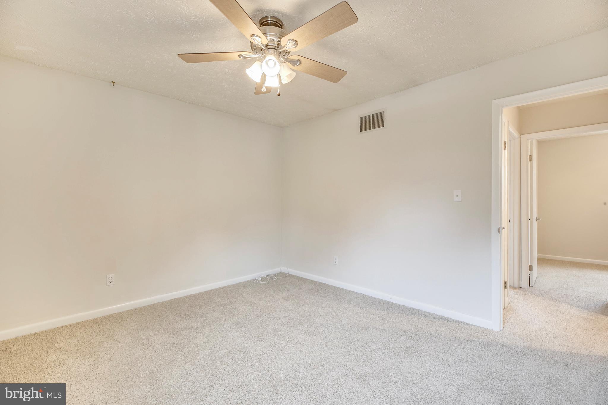 205 Burns Crossing Road Severn, MD 21144 - Photo 18 of 30 an empty room with a chandelier fan and windows
