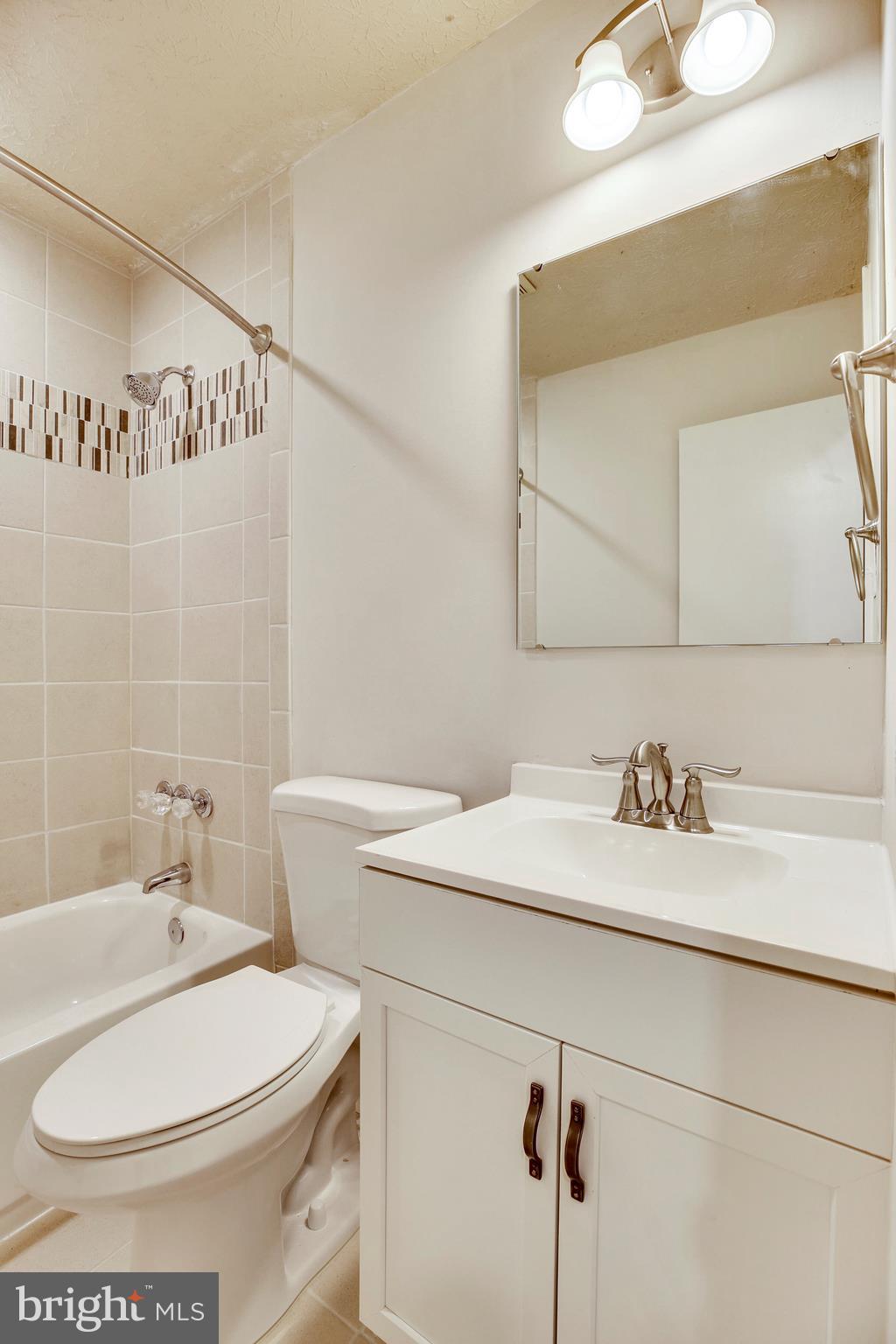 205 Burns Crossing Road Severn, MD 21144 - Photo 20 of 30 a bathroom with a sink a toilet and mirror