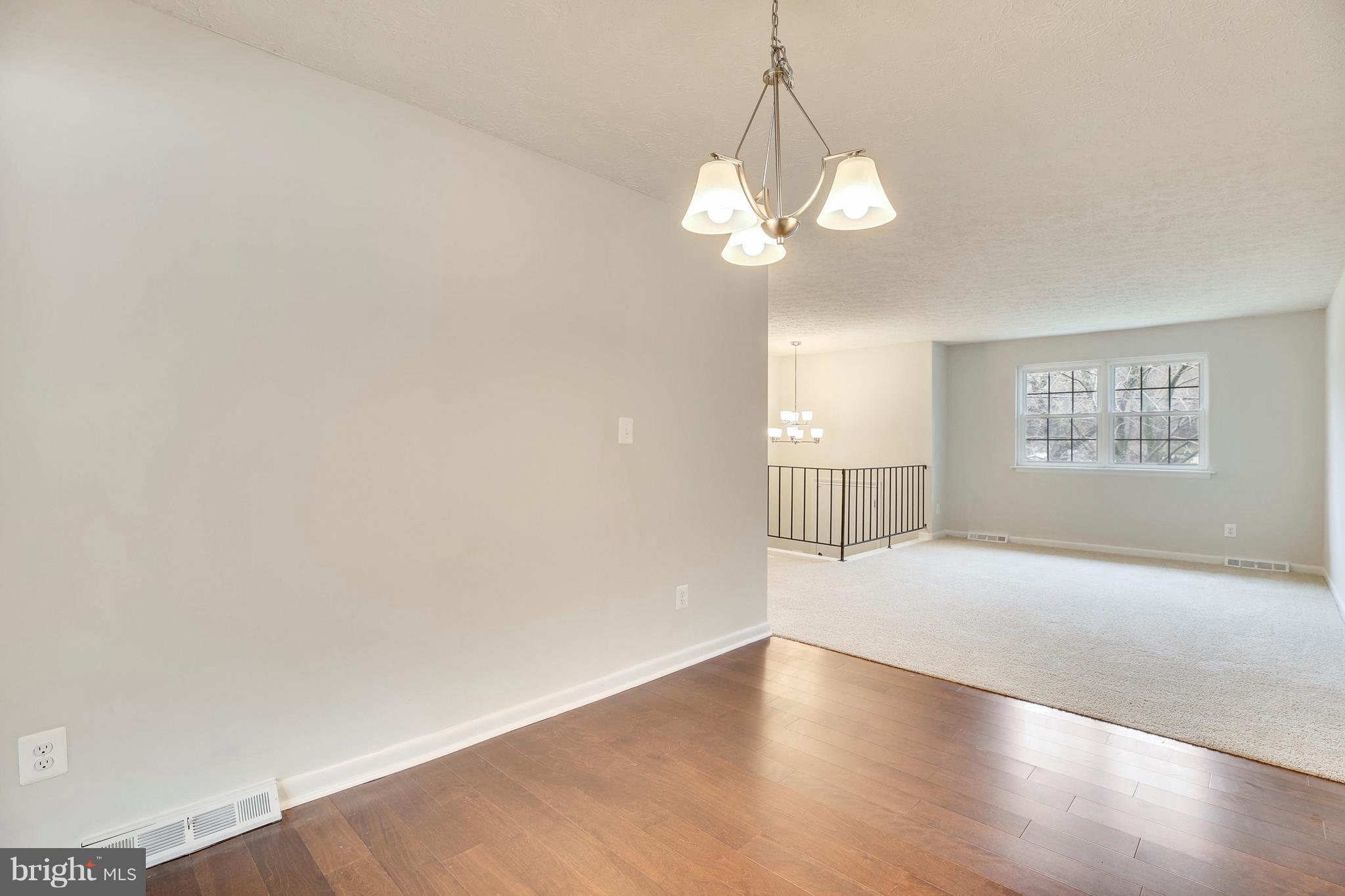 205 Burns Crossing Road Severn, MD 21144 - Photo 6 of 30 a view of an empty room with a window and wooden floor