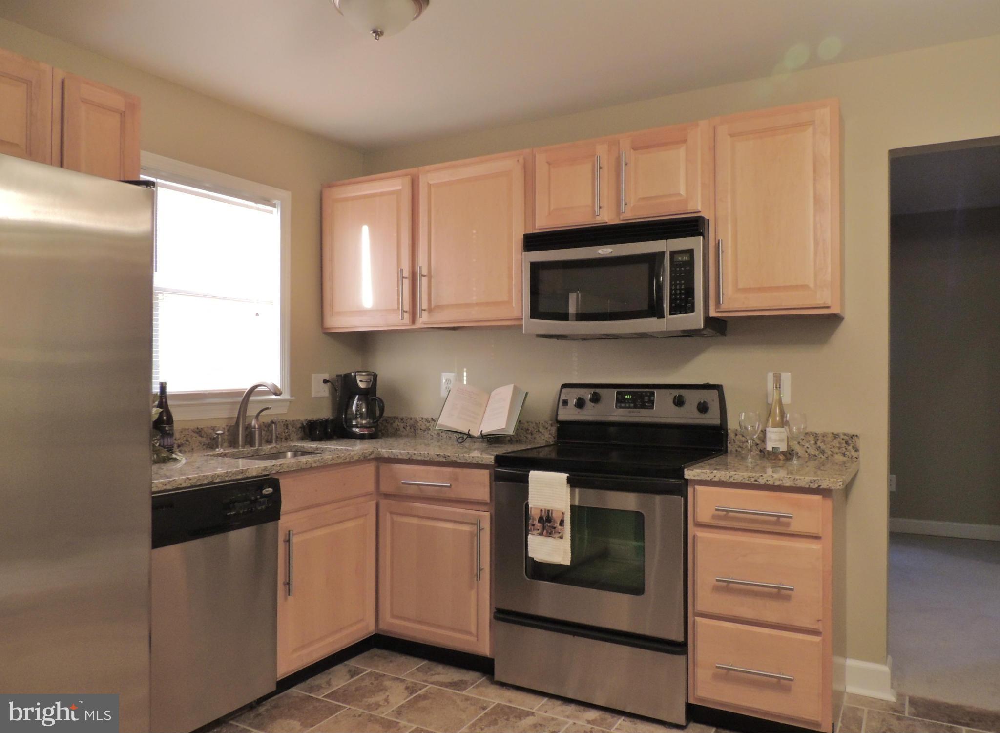 4803 Ebenezer Road Nottingham, MD 21236 - Photo 15 of 29 a kitchen with a sink stove and microwave