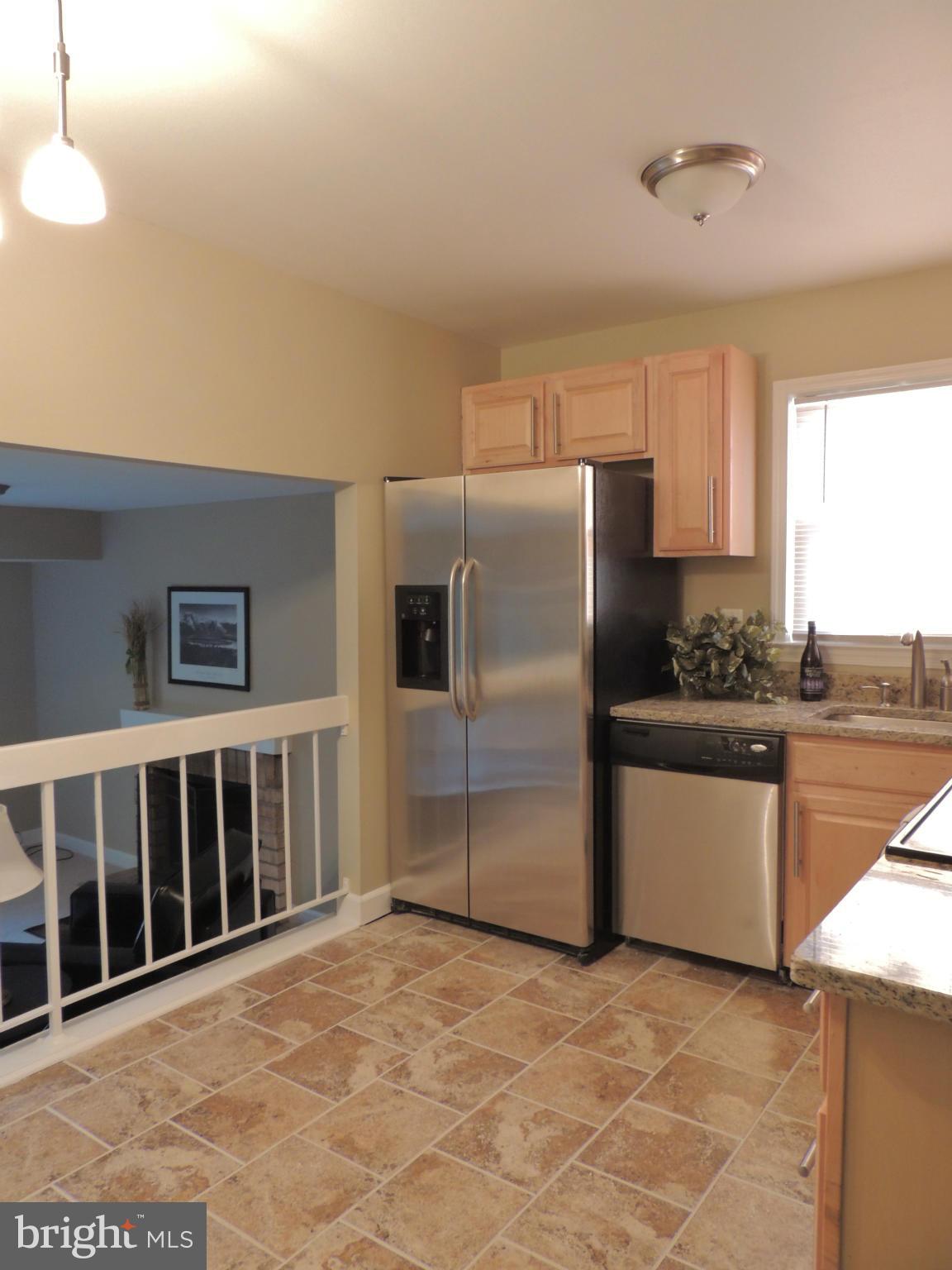 4803 Ebenezer Road Nottingham, MD 21236 - Photo 18 of 29 a kitchen with granite countertop a refrigerator and a stove top oven