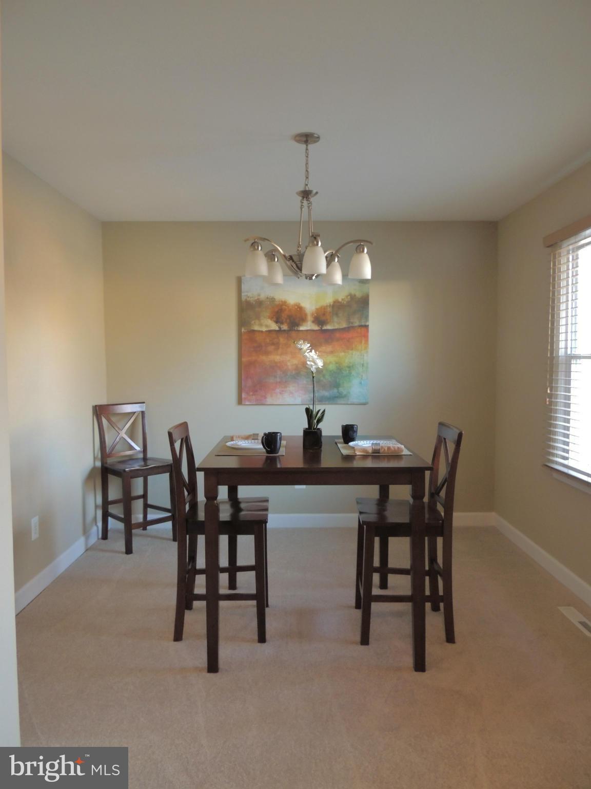 4803 Ebenezer Road Nottingham, MD 21236 - Photo 19 of 29 a view of a dining room with furniture and chandelier