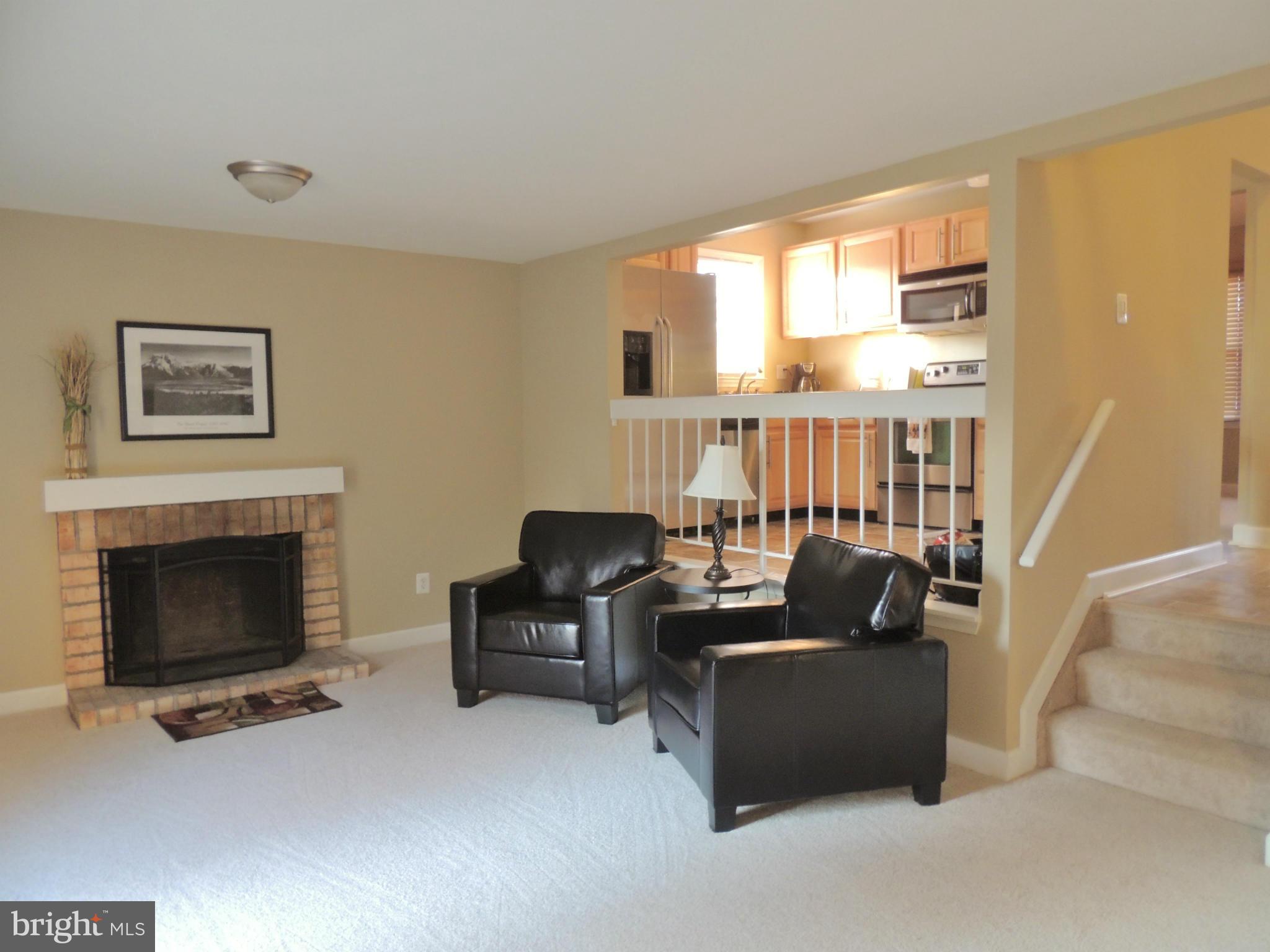 4803 Ebenezer Road Nottingham, MD 21236 - Photo 25 of 29 a living room with furniture a fireplace and a large window