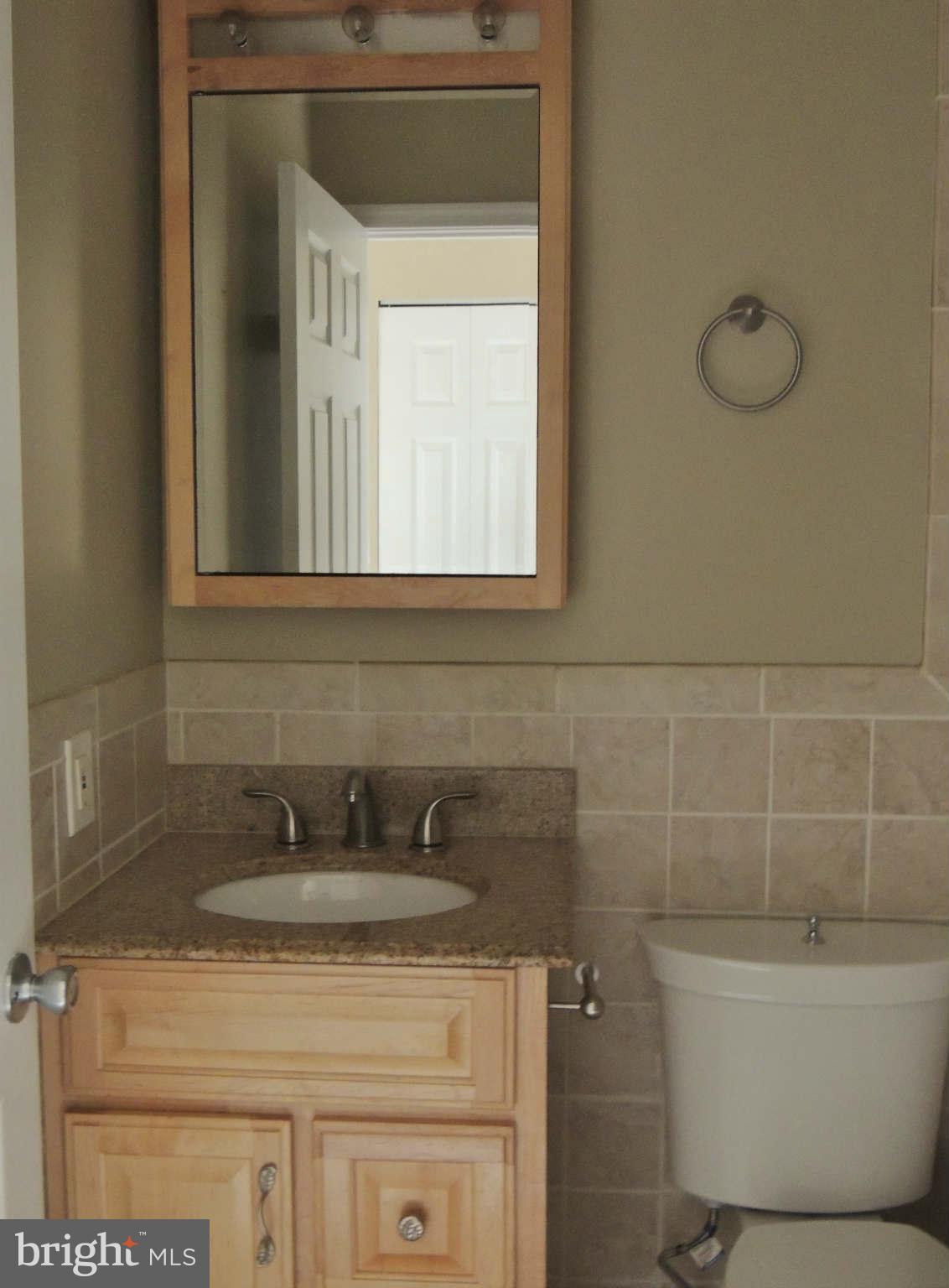 4803 Ebenezer Road Nottingham, MD 21236 - Photo 10 of 29 a bathroom with a sink and a mirror