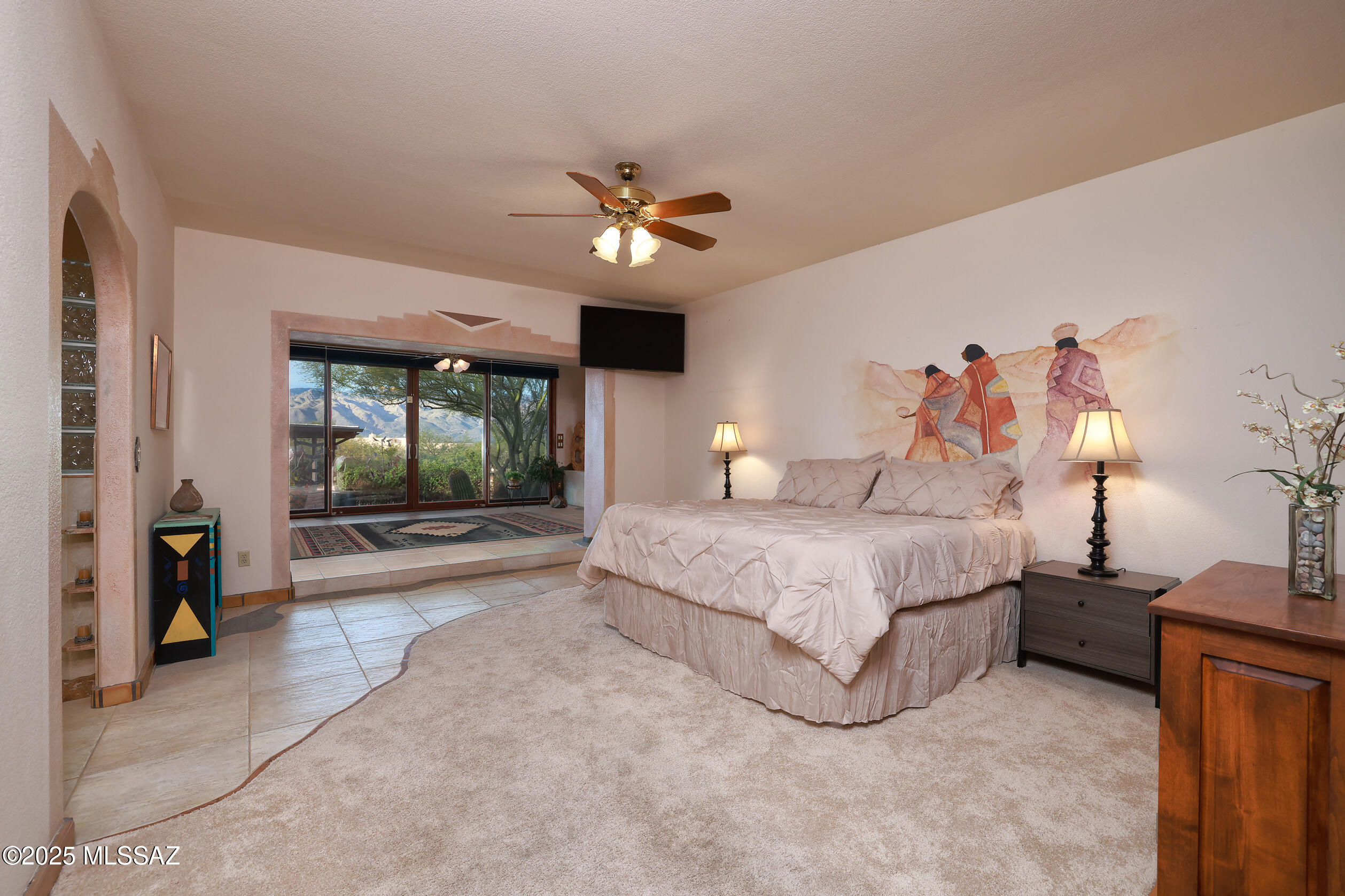 925 North Rancho Del Jefe Loop Tucson, AZ 85748 - Photo 8 of 52 a spacious bedroom with a large bed and a chandelier