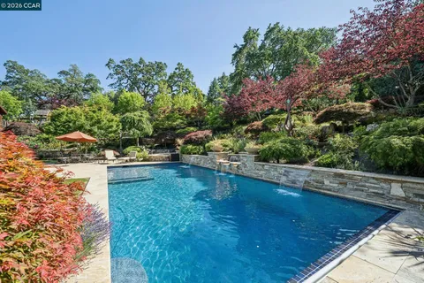 an aerial view of a house with garden space lake view and mountain view