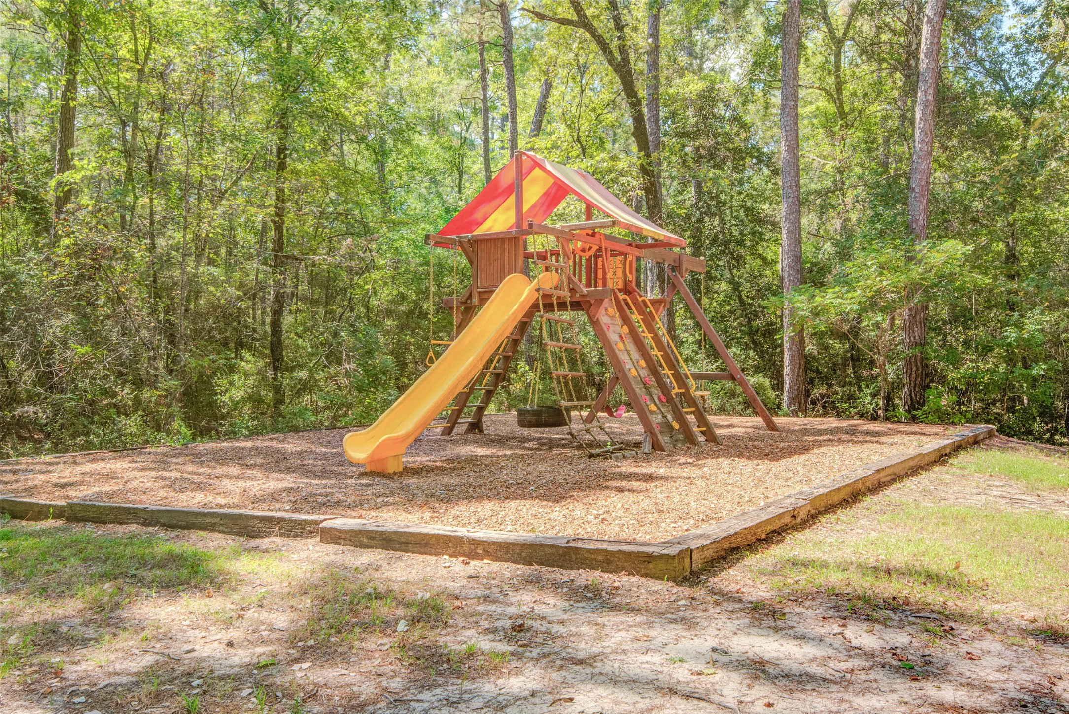 185 Rim Rock Road Huntsville, TX 77340 - Photo 15 of 19 a view of outdoor space with playground and tree