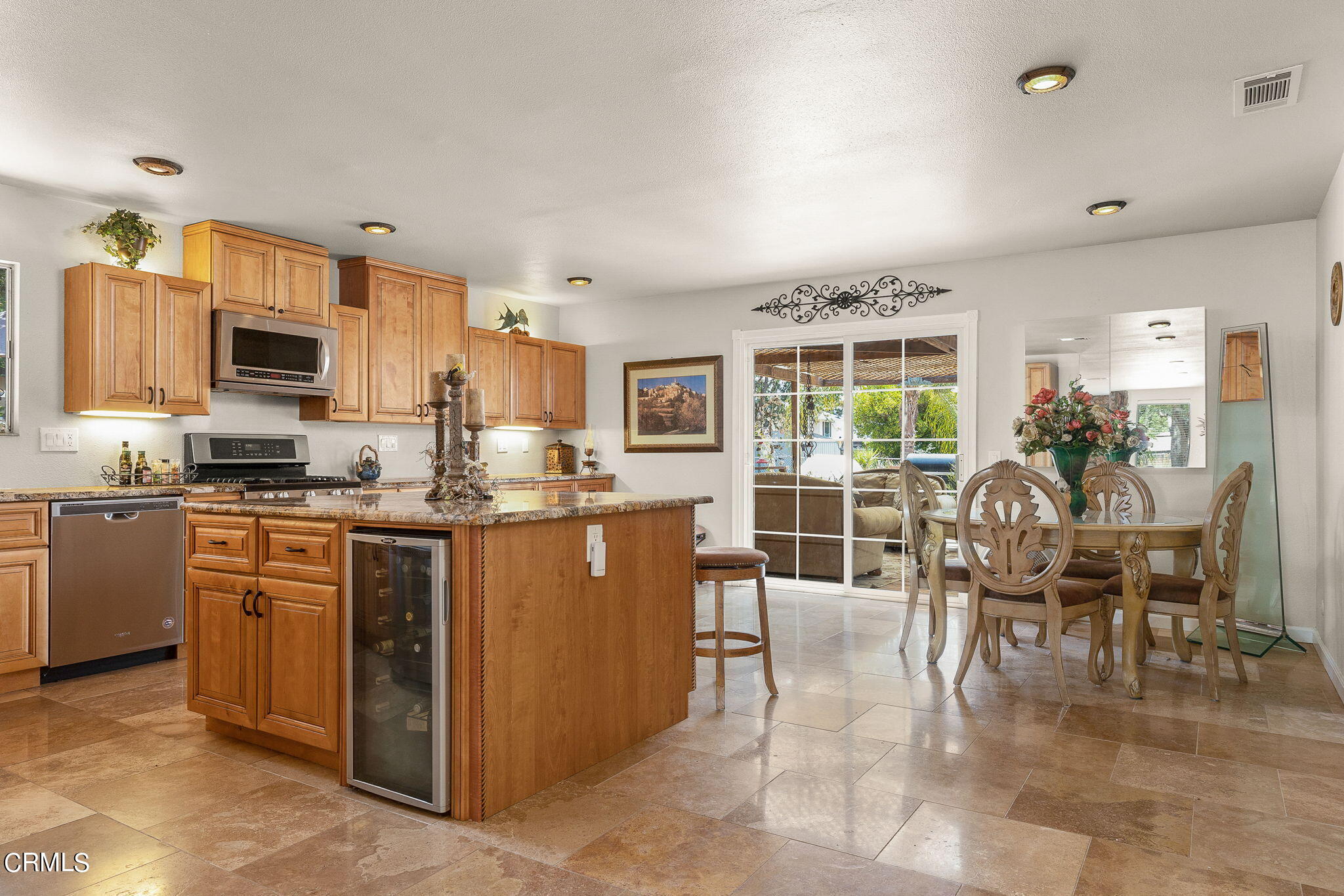 52 Grapevine Road Oak View, CA 93022 - Photo 11 of 52 a kitchen with kitchen island granite countertop a stove top oven a sink a dining table and chairs