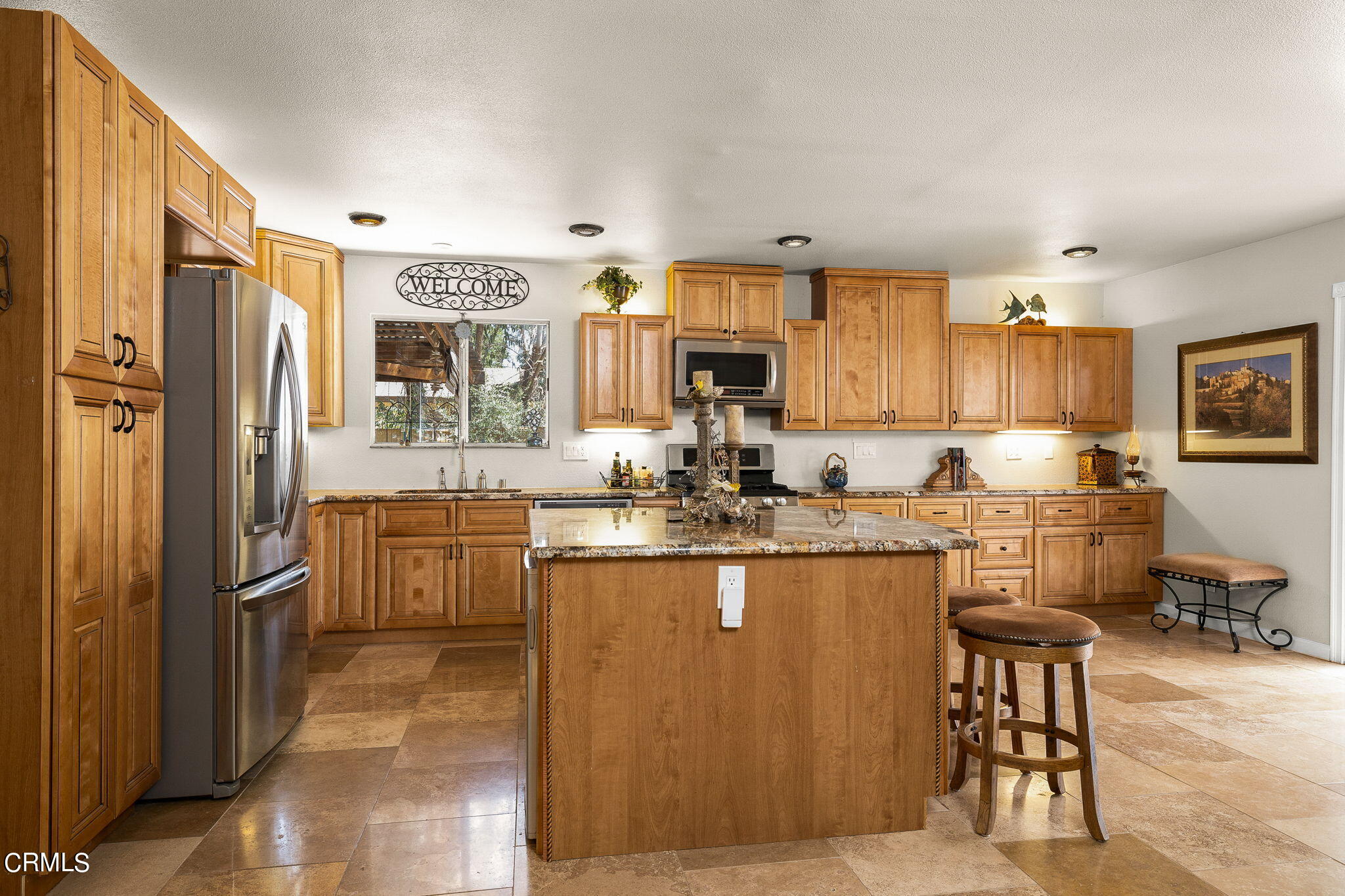 52 Grapevine Road Oak View, CA 93022 - Photo 12 of 52 a kitchen with stainless steel appliances granite countertop a refrigerator a sink dishwasher a stove with wooden cabinets and floor