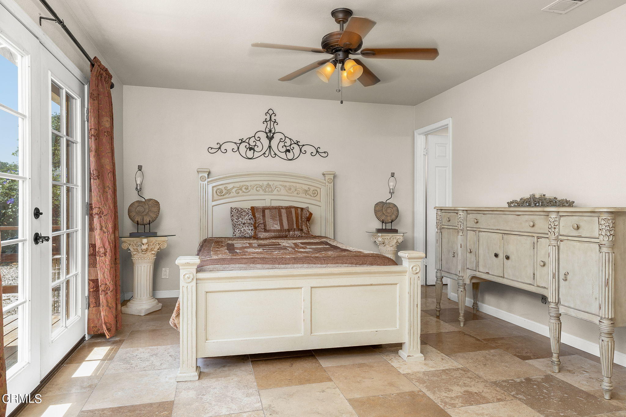 52 Grapevine Road Oak View, CA 93022 - Photo 16 of 52 a bedroom with a bed and a chandelier