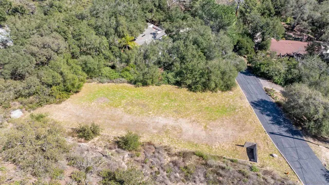 a view of a yard with wooden fence