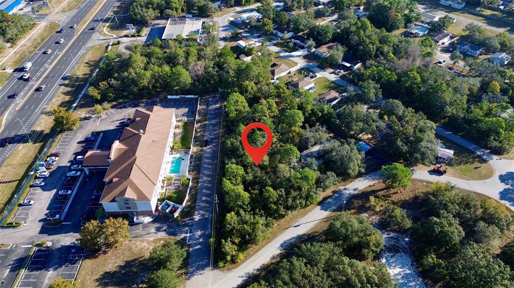 3560 Diagonal Lane Spring Hill, FL 34606 - Photo 11 of 12 an aerial view of residential house with outdoor space and swimming pool