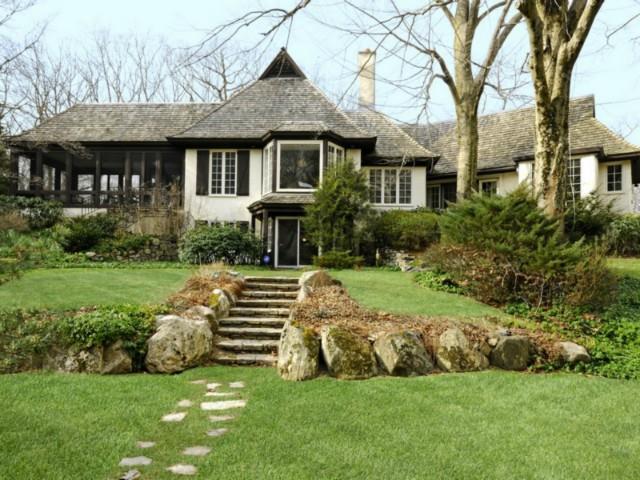 a front view of a house with a yard table and chairs
