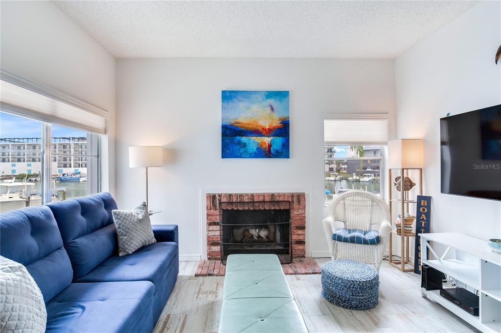 171 Medallion Boulevard, Unit H Madeira Beach, FL 33708 - Photo 15 of 44 a living room with furniture and a fireplace
