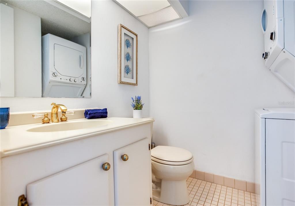 171 Medallion Boulevard, Unit H Madeira Beach, FL 33708 - Photo 17 of 44 a bathroom with a sink a toilet and a mirror