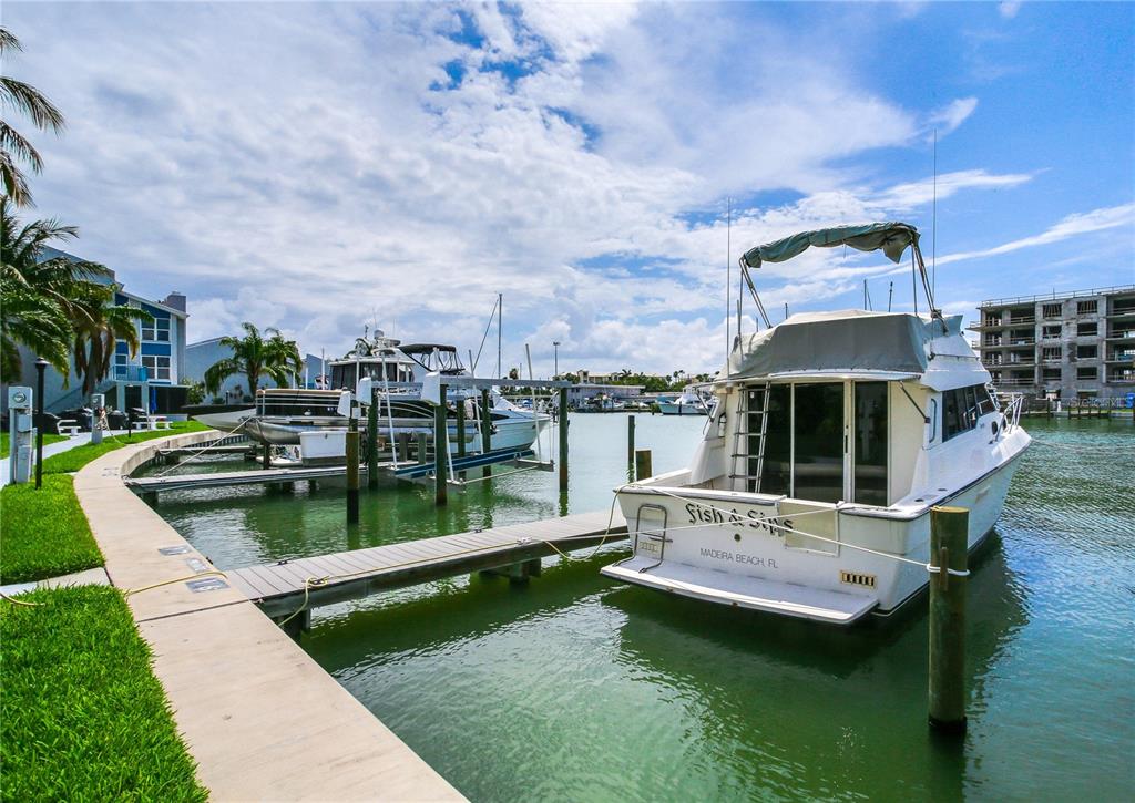 171 Medallion Boulevard, Unit H Madeira Beach, FL 33708 - Photo 41 of 44 a view of swimming pool with a yard