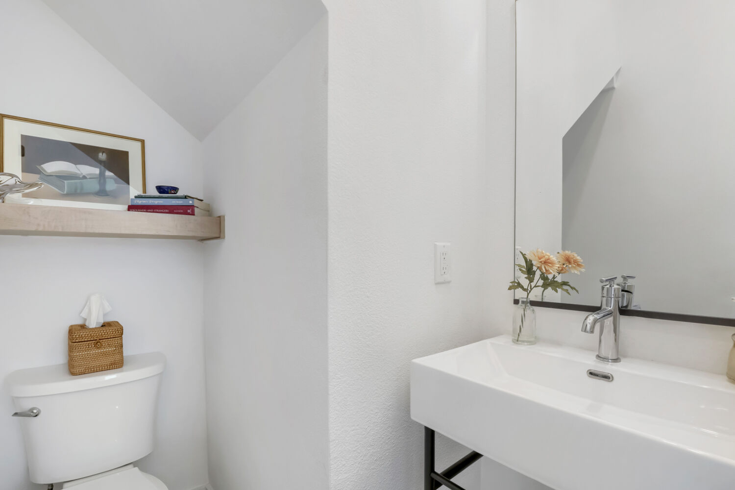 4804 Ribbecke Avenue, Unit A Austin, TX 78721 - Photo 21 of 32 This bathroom features a contemporary sink with a chrome faucet, a large mirror, and a wall-mounted shelf above the toilet