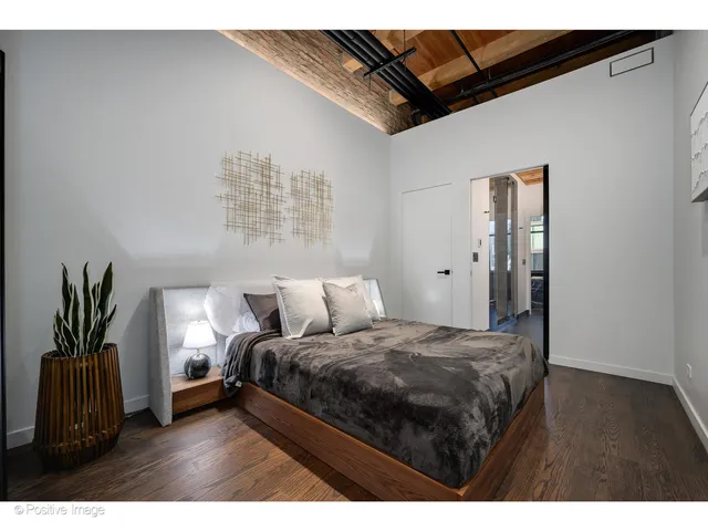 a bedroom with a bed and a potted plant