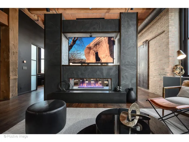 a living room with fireplace furniture and a flat screen tv