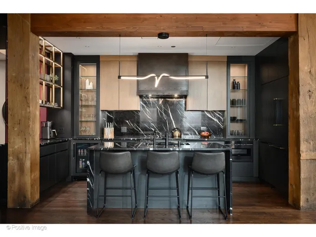 a kitchen view with a table and chairs