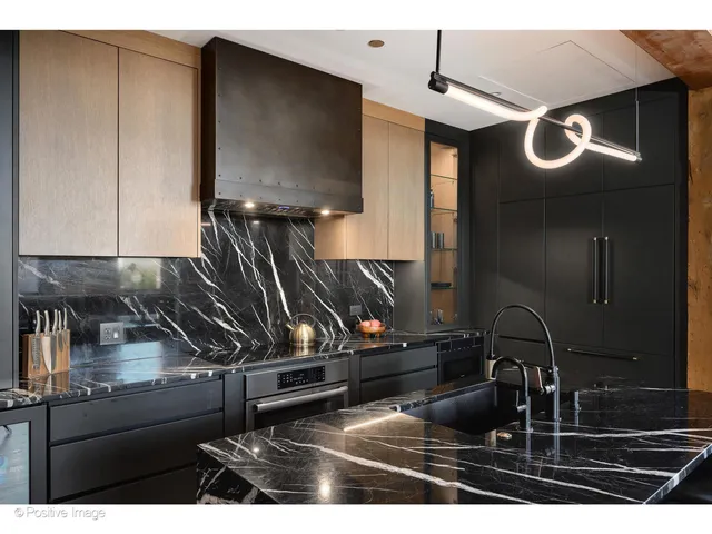 a kitchen with a refrigerator and a sink