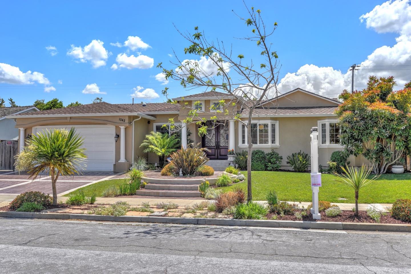 a front view of a house with garden