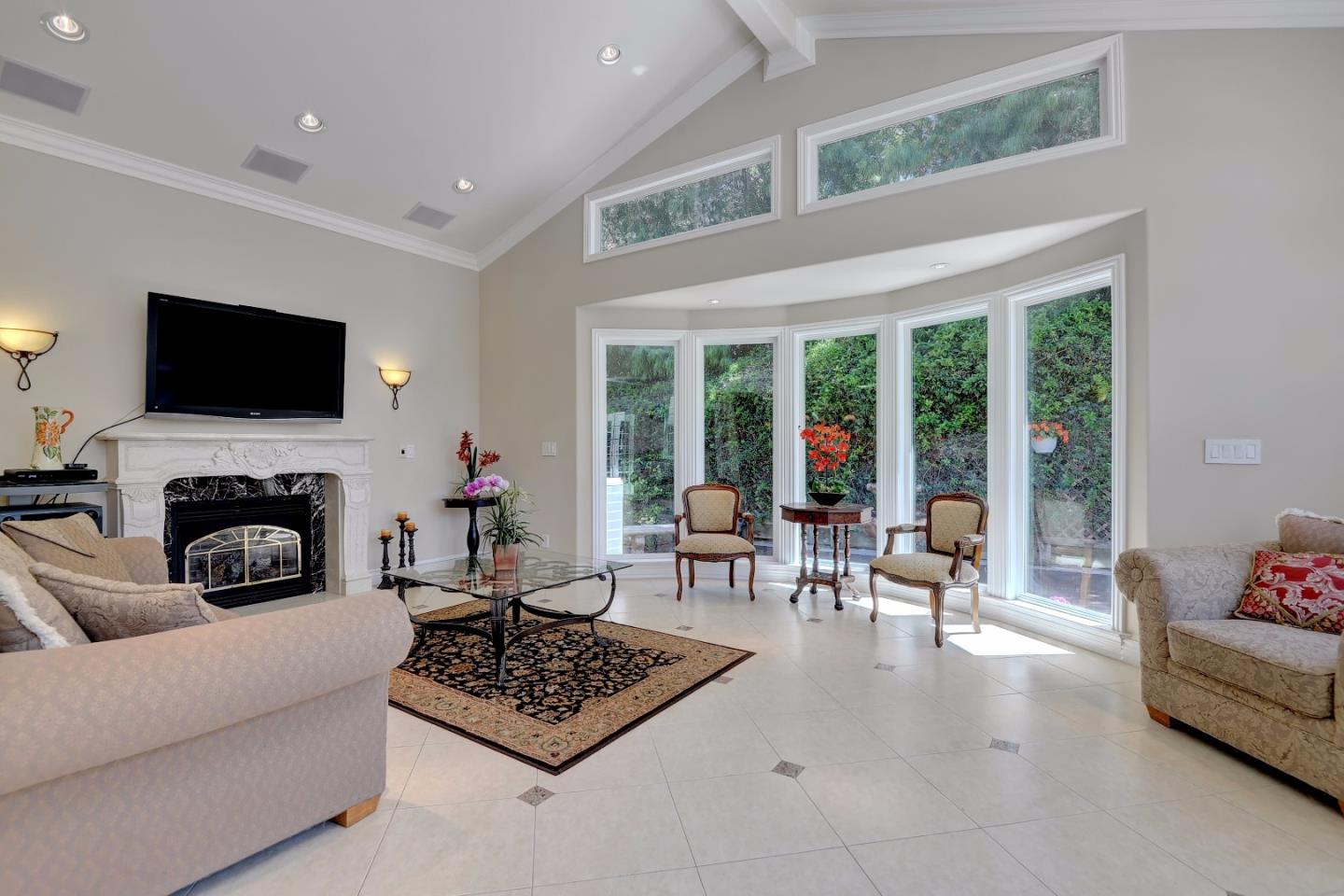 1042 Celilo Drive Sunnyvale, CA 94087 - Photo 13 of 27 a living room with furniture a fireplace and a flat screen tv