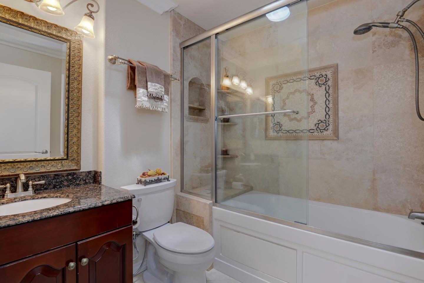 1042 Celilo Drive Sunnyvale, CA 94087 - Photo 19 of 27 a bathroom with a granite countertop sink toilet and shower