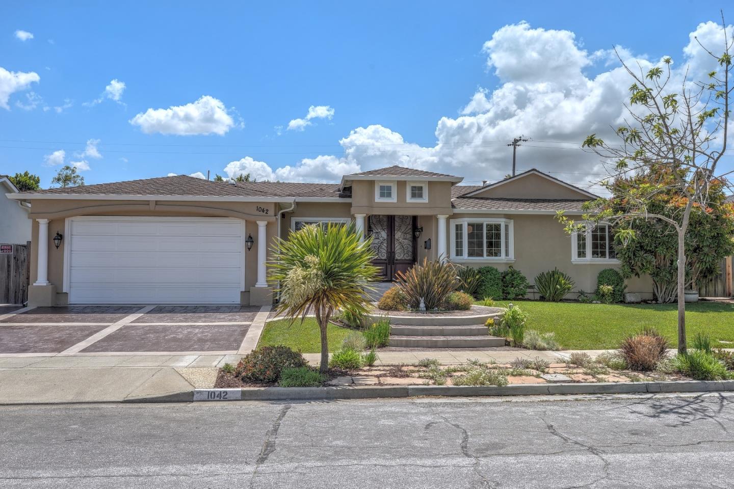 1042 Celilo Drive Sunnyvale, CA 94087 - Photo 2 of 27 a front view of a house with a yard and a garage